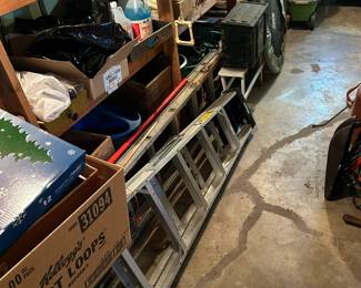 Basement, same shelves, ladders, trampoline, antique ammo box