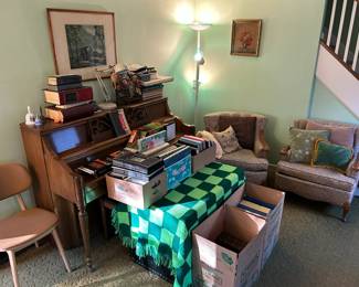 Living Room, piano and chairs and wall art and old books