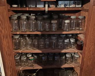 Basement, apothecary cabinet inside with old canning stuff