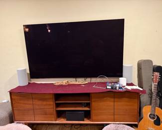 Walnut entertainment center and 63” smart tv