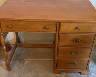 A midcentury laying desk with a fold up side table