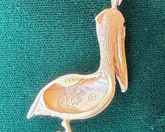 Lot#66 14k gold pelican pendant with emerald eyes