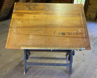 Vintage 1940s-1950s drafting table. Fully adjustable. Solid wood and iron adjusting mechanism for heights and angles. Perfect for drawing and painting. Great for art/drafting students learning the basics. This came from The New York Times graphics department before the change to computer generated graphics layouts.