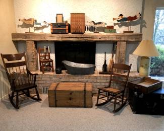 Antiques: rockers, trunks, boxes, metal baby bathtub. Folk art wood figures on stands.