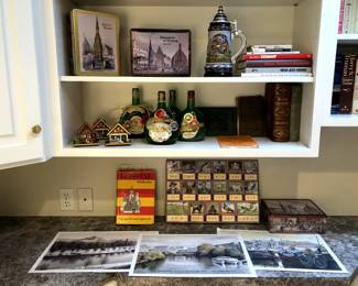 German books, some very old, German cookie tins, Franken Bocksbeutel wine bottles, stein, prints.