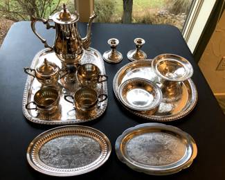 Silver plated tea set, trays, candle stick holders.