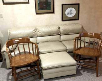 Light tan colored leather couch with ottoman: Classic Leather Inc., Hickory, N. Carolina. Two old wood Captain chairs.