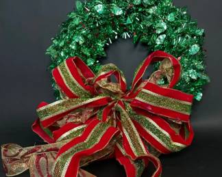 Faux holly tinsel wreath with red and gold bow