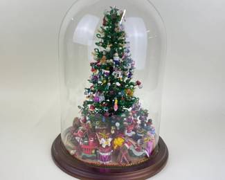 Beaded tree covered in ornaments under a cloche