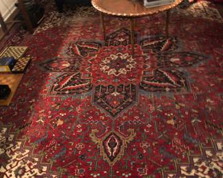 Large Persian carpet worn on opposite end