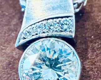 A fine quality custom made diamond pendant necklace set in 14k white gold offered with a substantial 14k chain the diamond approx 1.40-1.50 Ctw Modern brilliant cut with 4 small accent diamonds.