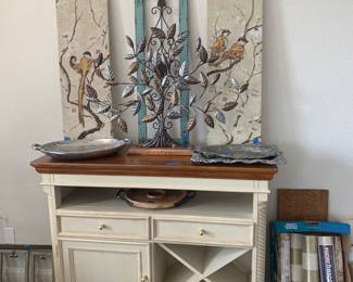 Farmhouse style buffet with wine storage and two line drawers
Miscellaneous artwork, serving trays, and wallpaper shown in photo