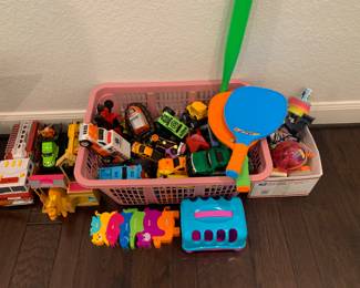 Lots of toy trucks and cars as well as educational items show in photo