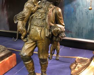 Bronze statue of a boy with dogs