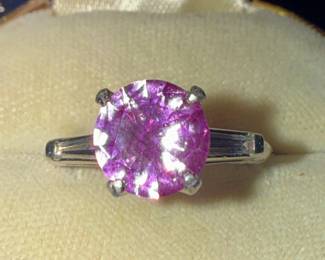 Vintage 1960s Platinum setting set with two baguette diamonds set with a pink sapphire.