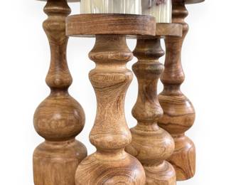 A Set of Four Graduated Wooden Candle Holders with Faux Berry Candles