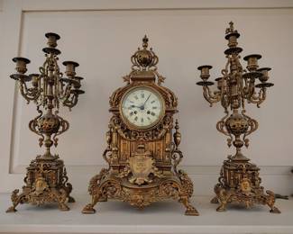 Grand antique bronze gilt French mantle clock with matching candelabras.