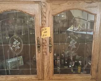 Oakwood China corner wall cabinet with a mirror ability.Glasses and deviled glasses cut perfect condition, it costs $600.Noise hundred ten dollars , have mini pieces
