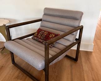 $400       "Curved chair with horizontal channels.
Silver fabric
Dark wood frame
27""W x 32""D x 31""H"	