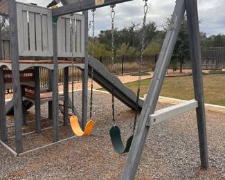 $500      Crafted from durable cedar with a weather-resistant gray finish, this playset combines fun and safety in one design. It includes two slides, two swing positions, a climbing wall, ladder, play deck with roof, and engaging accessories like a telescope and steering wheel. The sturdy build supports up to 600 lbs., with swing and slide weight limits of 200 and 300 lbs. respectively. ($2200 retail price) 