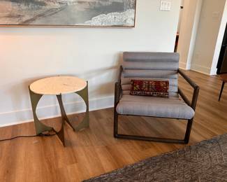 $400       "Curved chair with horizontal channels.
Silver fabric
Dark wood frame
27""W x 32""D x 31""H"	