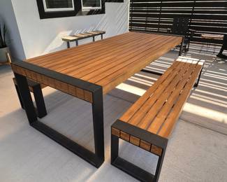$1200         Acacia wood will have variations in color and texture and will weather to a soft gray over time
Table Dimensions : 94.5"W x 39.5"D x 30"H
Bench Dimensions : 84.5"W x 15.5"D x 17.5"H"Outdoor Dining Table + Benches
(2) Benches
(1) Table
Constructed of solid acacia wood
Powder-coated steel legs
Slatted top and seat
For indoor and outdoor use					