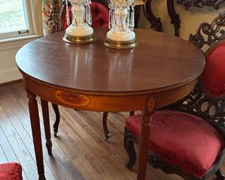 Game table suspected to be a Henkel piece. Has beautiful inlay, with tapered legs and brass tips