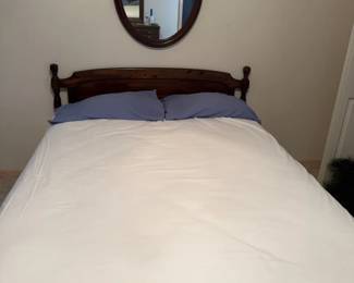 Wood Bed Frame with Mattress, Sheets, and Oval Wall Mirror