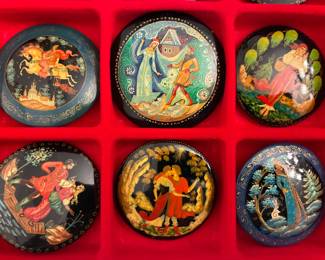 Intricately crafted Russian lacquerware — boxes, pins, and decorative pieces.