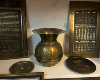 Brass spittoon, brass plates, brass calendar and plaque