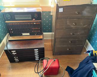 Handmade switchboard; vintage wooden card catalog of collector’s filing cabinet; vintage metal chest of drawers.