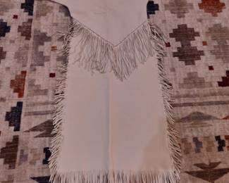 Beautiful white buckskin dress with elaborate fringes. Size 6-8. May be worn or framed.