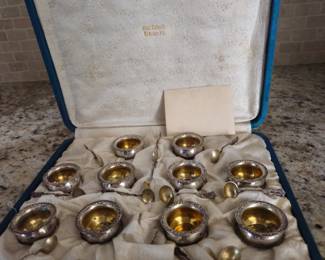 Boxed set of twelve sterling salts with spoons. Gilt lined spoon bowls as well as salt containers.