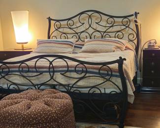 Adjustable king size bed with wrough iron frame, head and foot boards. One of two Mid-century Modern lamps.