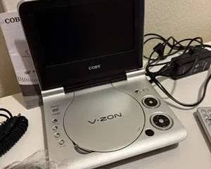 Coby V.ZON Portable DVD Player Silver on 7" Screen with Remote, AC Adapter and Car Charger