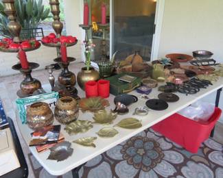 Trivets, candle sticks, brass and bronze trinket dishes, iron tractor seat.
