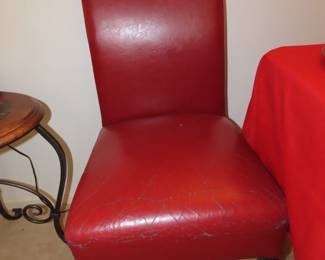 Two red leather dining chairs.