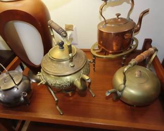 Collection of brass, metal, pewter and iron teapots and kettles.