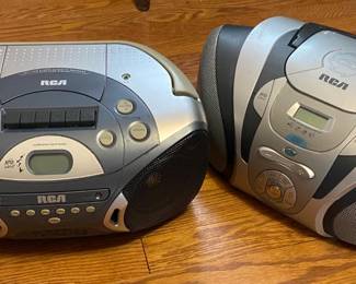 Device on left features a cassette player, CD player, as well as AM/FM radio. Device to the right has a CD player and AM/FM radio. Both work, and come with cords, though they also operate on battery.