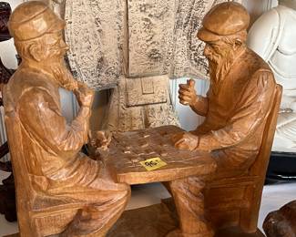 Hand carved wood men playing checkers