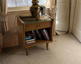 A Kent-Coffey "The Sharon" mid-century single-drawer walnut nightstand. This piece measures 22"W x 17"D x 25"H (1 available)