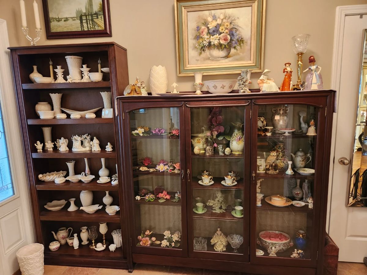 Very nice bookcase & early 1900 4-door oak bookcase with wavy glass. Both are filled with Lenox, Capodimonte, 2 carved (what we believe to be) jade pieces.