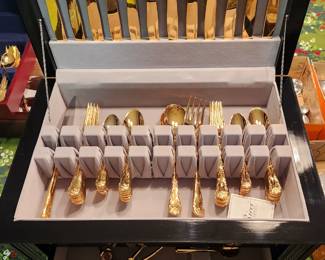Large silver chest full of gold flatware. 