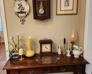 Nice sofa table, clocks, & beautiful art glass.