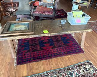 Primitive wood bench, antique rugs