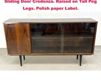 Lot 437 Mid Century Modern Polish Glass Sliding Door Credenza. Raised on Tall Peg Legs. Polish paper Label.