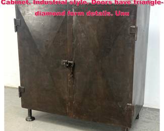 Lot 602 Contemporary Two Door Metal Cabinet. Industrial style. Doors have trianglediamond form details. Unu