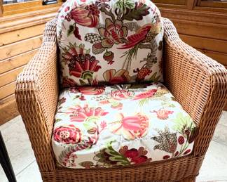 Wicker armchair with a white background floral cushion