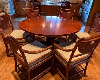 Baker Furniture Italian Empire style carved mahogany pineapple pedestal table with six Bradford chairs in a Bristol finish. 