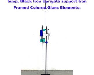 Lot 931 Svend Aage Holm Sorensen floor lamp. Black Iron Uprights support Iron Framed Colored Glass Elements.